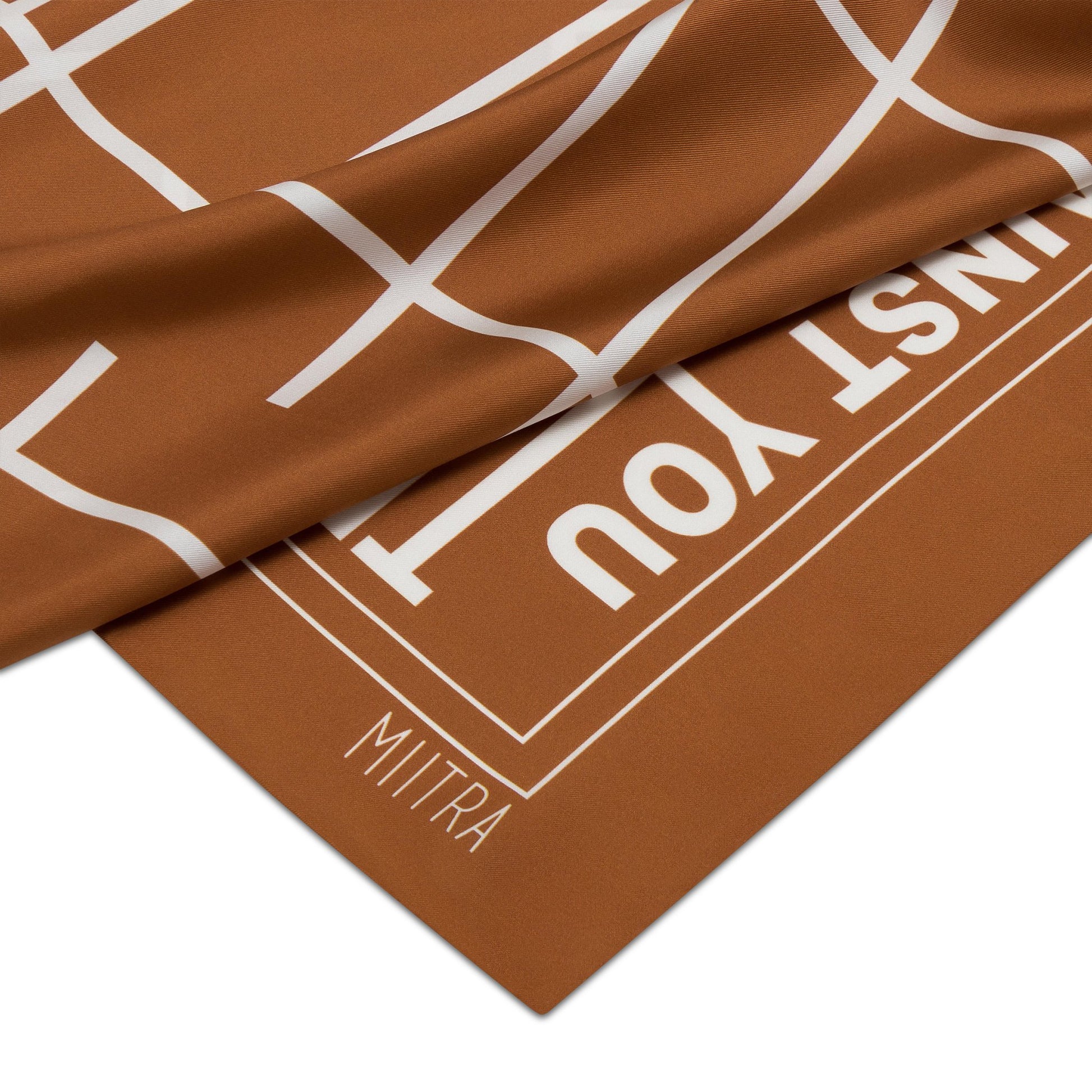 Close up view of the MIITRA logo on a brown silk scarf?id=22984471773371